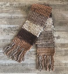 Stay warm and cute with this awesome neutral tone hand crochet scarf with fringe detail. This awesome color in "woodgrain" tweed is perfect for any outfit and occasion. Cozy up in this super soft and cozy hand crochet scarf made with love! Brown Yarn Scarf For Fall, Bohemian Brown Crochet Scarf, Fall Crochet Yarn Scarf, Crochet Acrylic Yarn Scarves For Fall, Fall Crochet Scarves In Acrylic Yarn, Fall Crochet Scarf In Acrylic Yarn, Crochet Yarn Scarves For Cold Weather, Warm Brown Scarves For Cold Weather, Warm Brown Scarf For Cold Weather