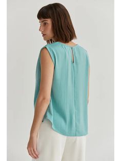 Expertly crafted with a relaxed fit, this sleeveless cowl neck blouse boasts a crushed satin fabric that exudes elegance. Perfect for any occasion, the Misty Mint color adds a touch of sophistication to your wardrobe. Misty Mint Cowl Neck Blouse Color - Mint Pleat Detail on Shoulders Keyhole Detail with Button Closure at Back 97% Polyester 3% Spandex Sleeveless Rayon Top For Work, Casual Sleeveless Viscose Blouse, Elegant Sleeveless Rayon Tops, Chic Sleeveless Rayon Blouse, Chic Rayon Tank Top, Casual Sleeveless Silk Top, Sleeveless Silk Padded Blouse, Cowl Neck Blouse, Turquoise Bead Earrings