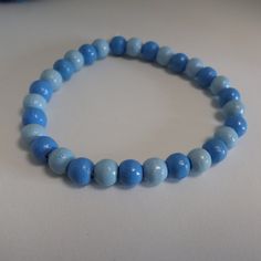 A blue Bracelet with Wooden beads The wood beads are threaded on an eco elastic band. (made out of cotton and natural rubber) Colours: Beads: light blue, middle blue Elastic band: white Colour and shape of the beads may vary since these beads are natural materials Size: Please measure the breadth of your wrist in cm . When in doubt, pick 1cm more to make sure it's comfortable. Size of the beads: ca 6mm Handmade in Germany The Pictures are examples, since every product is made by hand there are n Cheap Light Blue Round Beads Bracelets, Blue Wooden Beaded Bracelets For Beach, Adjustable Blue Beaded Bracelets With Wooden Beads, Blue Wooden Beads Bracelet, Casual Blue Beaded Stretch Bracelet, Light Blue Beaded Bracelets With Round Beads, Everyday Blue Hand-strung Beaded Bracelets, Casual Blue Beaded Bracelet With Large Beads, Casual Blue Bracelets With Large Beads