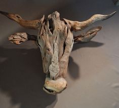 an animal's head made out of drift wood