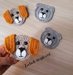 three crocheted dogs are shown with their ears turned to look like they're wearing hats