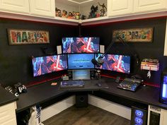 a computer desk with multiple monitors and other electronic equipment on it's sides in a room