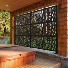 an outdoor jacuzzi is shown in front of a wooden wall and steps leading up to it