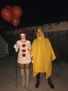 two people in costumes standing next to each other with balloons on their heads and hands