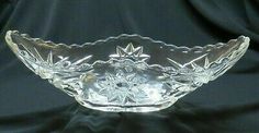 a clear glass bowl sitting on top of a black cloth