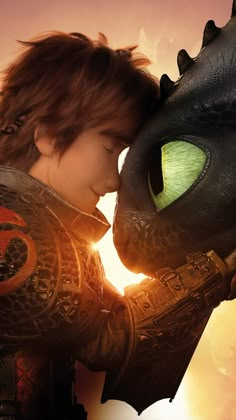 a young boy is kissing the head of a dragon in how to train your dragon