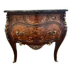 an ornate wooden chest with marble top and drawers on legs, sideboard or cabinet