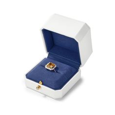 an open white box with a ring inside