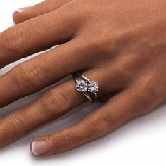 a woman's hand with a diamond ring on it