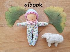 an image of a doll next to a sheep on a wooden surface with the words eibook written above it