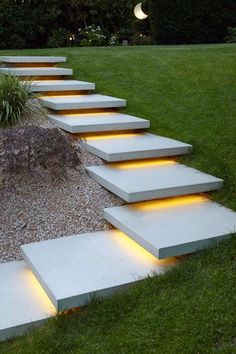 some steps lit up with lights in the grass