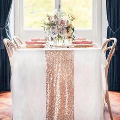 the table is set with pink and white flowers