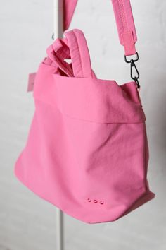 Meet your new BFF - the Carrie Catch All Shoulder Tote Bag! This trendy athleisure bag is perfect for gym days, running errands, or just looking stylish on the go. Comes in multiple colors including black, white, fuchsia, and lilac. Includes a removable strap, inner zipper pocket, and middle divider that also has a zipper pocket for all your essentials. Plus, a latch closure for extra security. Sporty Everyday Shoulder Bag With Double Handle, Sporty Shoulder Bag With Adjustable Strap For Everyday, Pink Nylon Gym Bag, Sporty Shoulder Bag For Everyday Use, Pink Large Capacity Shoulder Bag For Gym, Large Capacity Pink Shoulder Bag For Gym, Pink Large Capacity Casual Gym Bag, Casual Pink Gym Bag With Large Capacity, Sporty Travel Bags For Spring