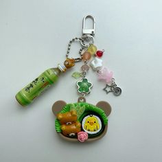 a keychain with a bear and other items on it