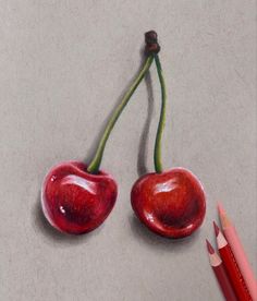 a drawing of two cherries on a piece of paper next to a crayon pencil