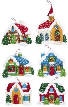 four christmas ornament ornaments with houses and trees on the front, one has a santa