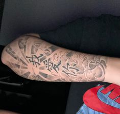 a man's arm with tattoos on it and the words written in black ink