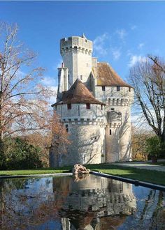 an old castle is reflected in the water