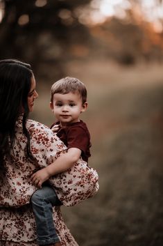 a woman holding a small child in her arms