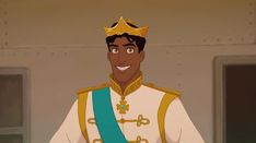 an animated man in a blue and gold outfit with a smile on his face wearing a tiara