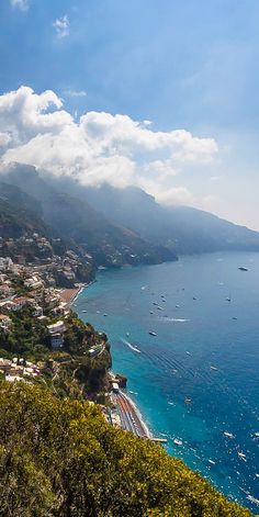 the ocean is full of boats on it's way down to the town and beach