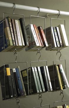 there are many books that are on the shelf in this room and one is hanging off the wall