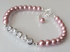 Wedding Powder Rose Blush Pink Colored Pearl Cubic Zirconia Dainty Bridal Bracelet. BRACELET is about 7.32 inches (18.6cm) long plus 1 inch extender chain. BRIDAL EARRINGS SECTION: https://www.etsy.com/shop/LanaChayka?ref=seller-platform-mcnav§ion_id=11638940 BRIDAL JEWELRY SETS SECTION: https://www.etsy.com/shop/LanaChayka?ref=seller-platform-mcnav§ion_id=25839214 BRIDAL NECKLACES SECTION: https://www.etsy.com/shop/LanaChayka?ref=seller-platform-mcnav§ion_id=11638944 Elegant and simple, this stunning bracelet is perfect for weddings or special occasions such as birthdays, anniversaries, graduations, proms...or whatever you can imagine! Handmade bracelet, is made with Powder Rose Blush Pink colored high quality European round crystal pearls, Rhodium Plated connector with Clear Cubic Zircon Pink Pearl Bracelet For Wedding, Adjustable Pink Crystal Bracelet For Wedding, Crystal Bracelet With Round Beads For Wedding, Adjustable Rose Gold Pearl Bracelet For Wedding, Adjustable Rose Gold Beaded Bracelet For Wedding, Adjustable Pink Pearl Bracelet For Weddings, Elegant Pink Crystal Bracelet For Formal Events, Elegant Pink Crystal Bracelet, Adjustable Pink Bracelets For Wedding