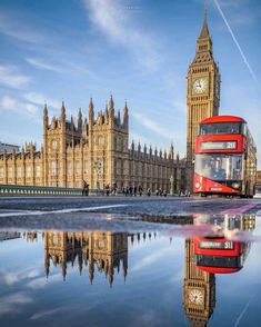 a red double decker bus driving past the big ben clock tower in london, england