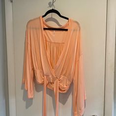 Nwot Free People Bell Sleeve Tie Crop Top. Extra Small But Fits More Like A Medium. Large Plunge Neckline. Super Soft Cotton Material. More Of A Coral Light Pink But Showing Orange In Pictures Light Pink Tops, Tie Crop Top, Plunging Neckline, Free People Tops, Pink Tops, Cotton Material, Bell Sleeves, Free People, Light Pink