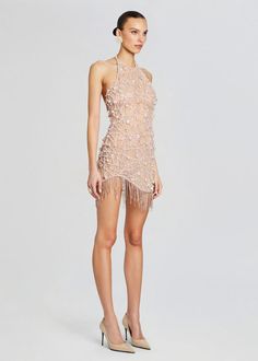 Dazzle and delight in our Livana Dress, featuring a chic high neck, alluring open back, and a playful fringed hem. Elevate your style game with this stunning ensemble that's guaranteed to make a statement at any event. Whether you're hitting the dance floor at a cocktail party or making a grand entrance at a special ev Fitted Beaded Fringe Flapper Dress For Summer, Fitted Fringe Flapper Dress For Summer, Fitted Flapper Dress With Tassels For Cocktail, Spring Mini Dress With Rhinestone Fringe, Glamorous Mini Dress With Tassels For Spring, Glamorous Tasseled Mini Dress For Spring, Fitted Mini Dress With Tassels For Cocktail, Summer Party Flapper Dress With Beaded Fringe, Summer Party Flapper Dress With Rhinestone Fringe