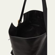 Wandler "Marli" tote bag in leather Adjustable shoulder strap Fold-over flap top with magnetic closure  Lining: Cotton Approx. 8.7"H x 9.8"W x 3.9"D Made in Italy Black Leather Tote Bag, 7 H, Leather Tote Bag, Magnetic Closure, Leather Tote, Tops Designs, Shoulder Strap, In Italy, Tote Bag