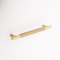 a gold colored handle on a white background