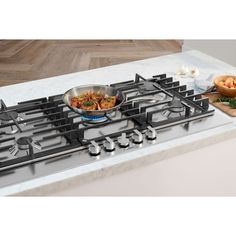 a stainless steel stove top with two pans on it