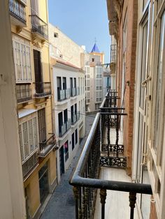 an alley way with buildings and balconies in the background