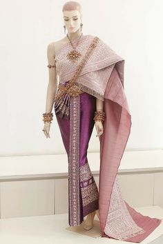 a mannequin dressed in purple and pink with an elaborate shawl over her head