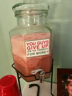 a jar filled with pink stuff sitting on top of a table