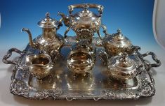 an ornate silver tea set on a tray