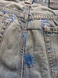 the back pocket of a pair of jeans with blue stitching on it and an embroidered design