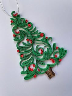 an ornament made to look like a christmas tree with red berries on it