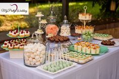 a table topped with lots of desserts and sweets