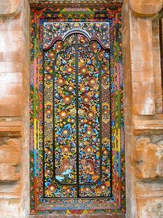 an ornate stained glass window in the middle of a building