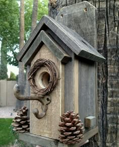 a bird house with pine cones on the outside