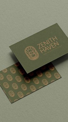 two business cards on top of each other with the logo for an artisan company