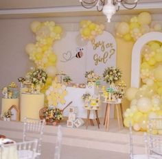 a room filled with lots of yellow and white balloons on top of it's walls