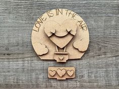 a wooden sign that says love is in the air