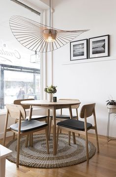 a dining room table with two chairs next to it