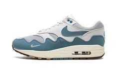 The Patta x Nike Air Max 1 “Noise Aqua” is one of several colorways of the vintage running shoe designed by the Amsterdam-based sneaker boutique and Nike.  The “Noise Aqua” reimagines the Air Max 1’s signature mudguard in a new wavy design for a fresh look.  The upper features a white mesh base with tonal leather overlays.  The Swoosh detailing on either side and the aforementioned wavy mudguard appear in Noise Aqua-colored suede.  Moreover, the classic “Nike Air” and Swoosh branding on the back Nike Air Max 1 Patta, Running Shoes Design, Sneaker Boutique, White Jordans, Aqua Shoes, Nike Sb Dunk, Nike Air Max 1, Stadium Goods, Aqua Color