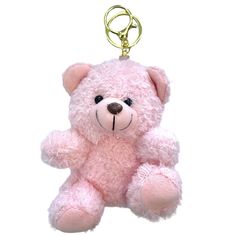 a pink teddy bear keychain hanging from a hook