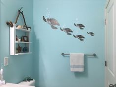 a bathroom with blue walls and sea animals on the wall