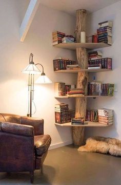 an image of a living room with bookshelves on the wall and leather chair